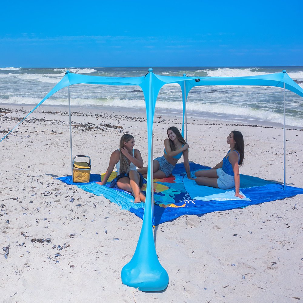 Sun Ninja 5x5 four-pole beach sun shelter canopy staked over the sand