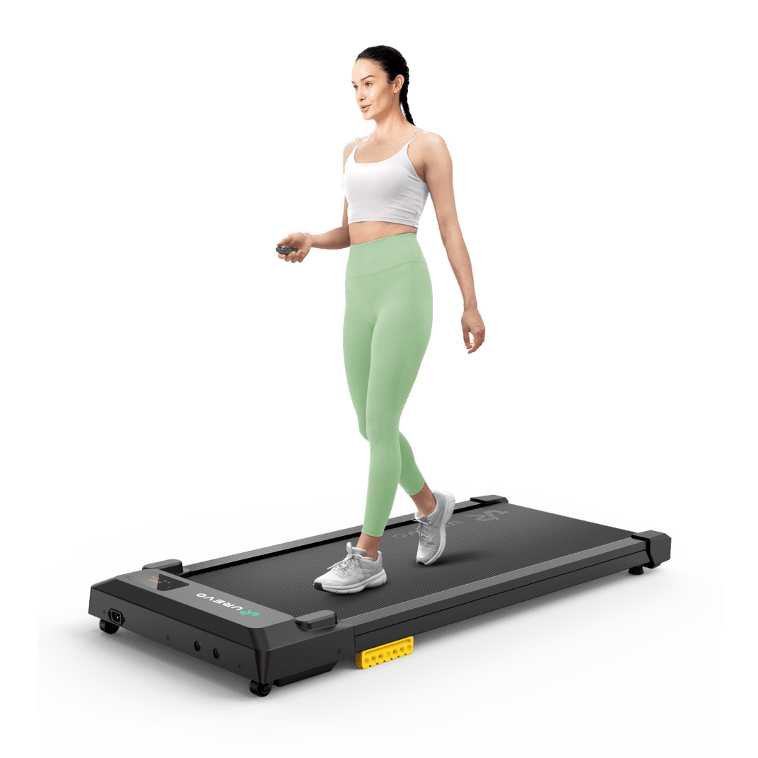 UREVO Smart Walking Pad flat under-desk treadmill in black with a person walking on the belt and a handheld remote