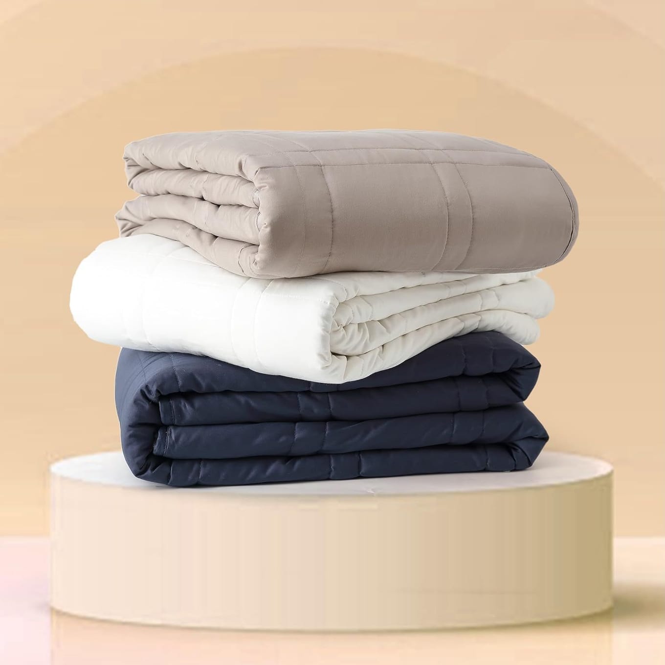 Baloo weighted blanket in pebble white shown quilted with visible boxed stitching and breathable cotton cover