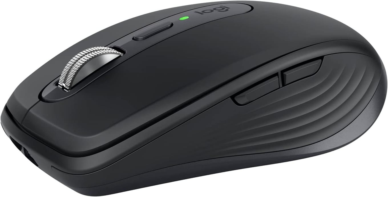 Logitech MX Anywhere 3S compact travel mouse with metal scroll wheel beside a laptop