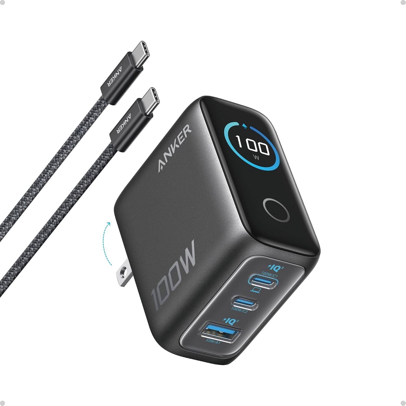 Black Anker charger with a round display reading 100 W, folding prongs, two USB-C ports and one USB-A port, beside a braided USB-C cable