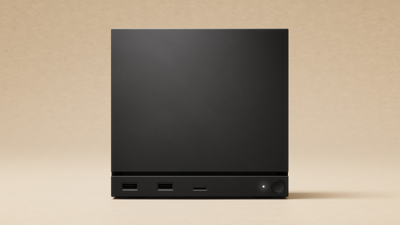 An M.2 NVMe SSD standing next to a Valve Steam Machine cube console