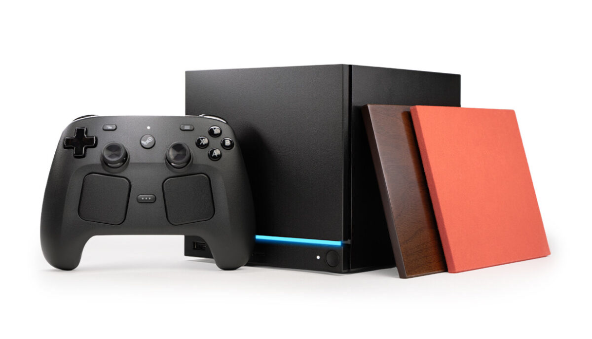 Valve Steam Machine cube console surrounded by accessories: an M.2 SSD, microSD card, controller and display cable