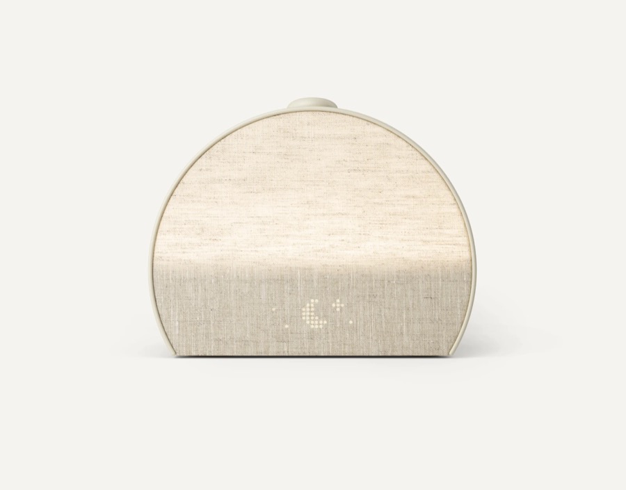 Hatch Restore 3 putty linen half-moon sunrise alarm clock with a subtle glowing time display on a white background