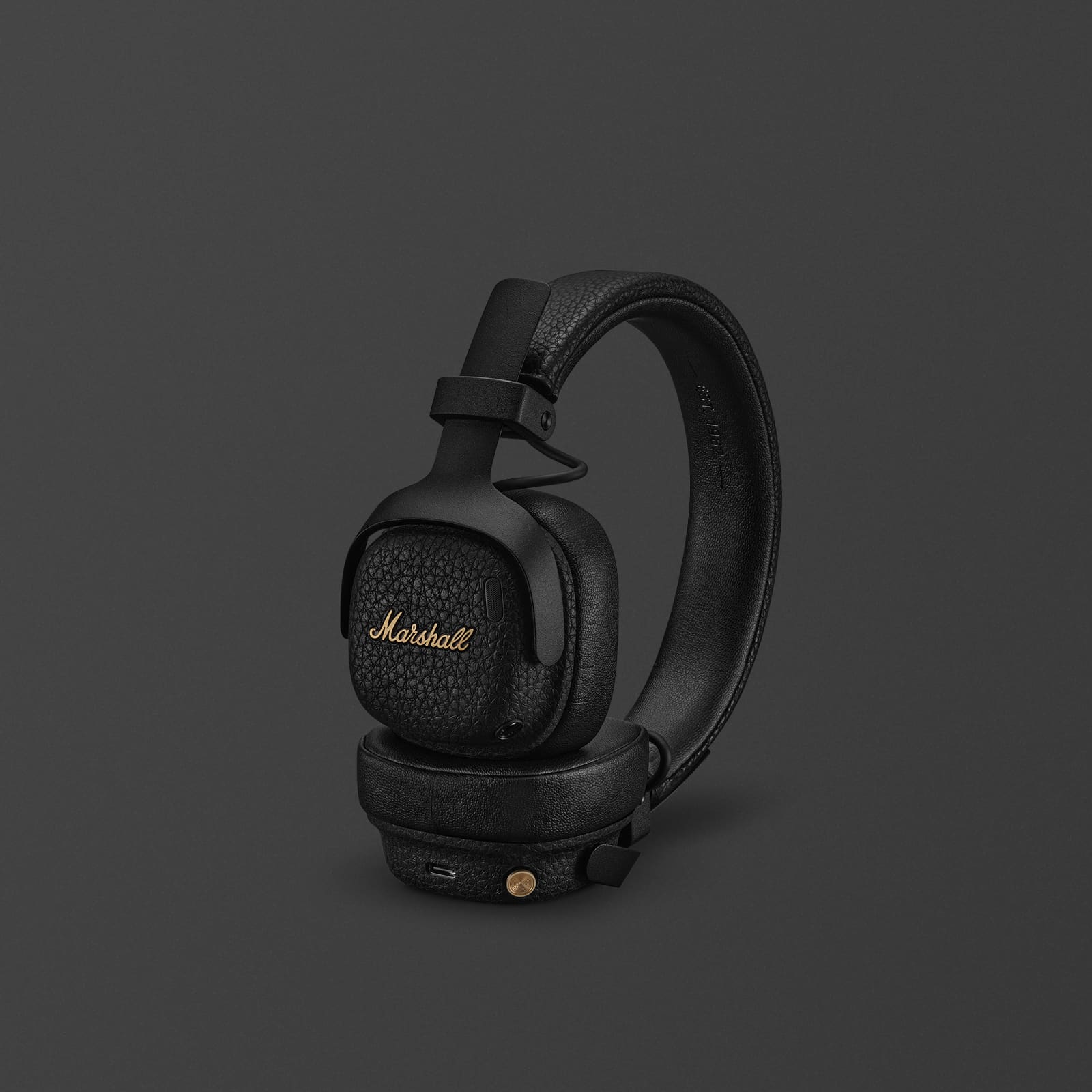Marshall Milton A.N.C. foldable on-ear wireless headphones in black with textured Marshall script logo on the earcups and brass-tone control knob