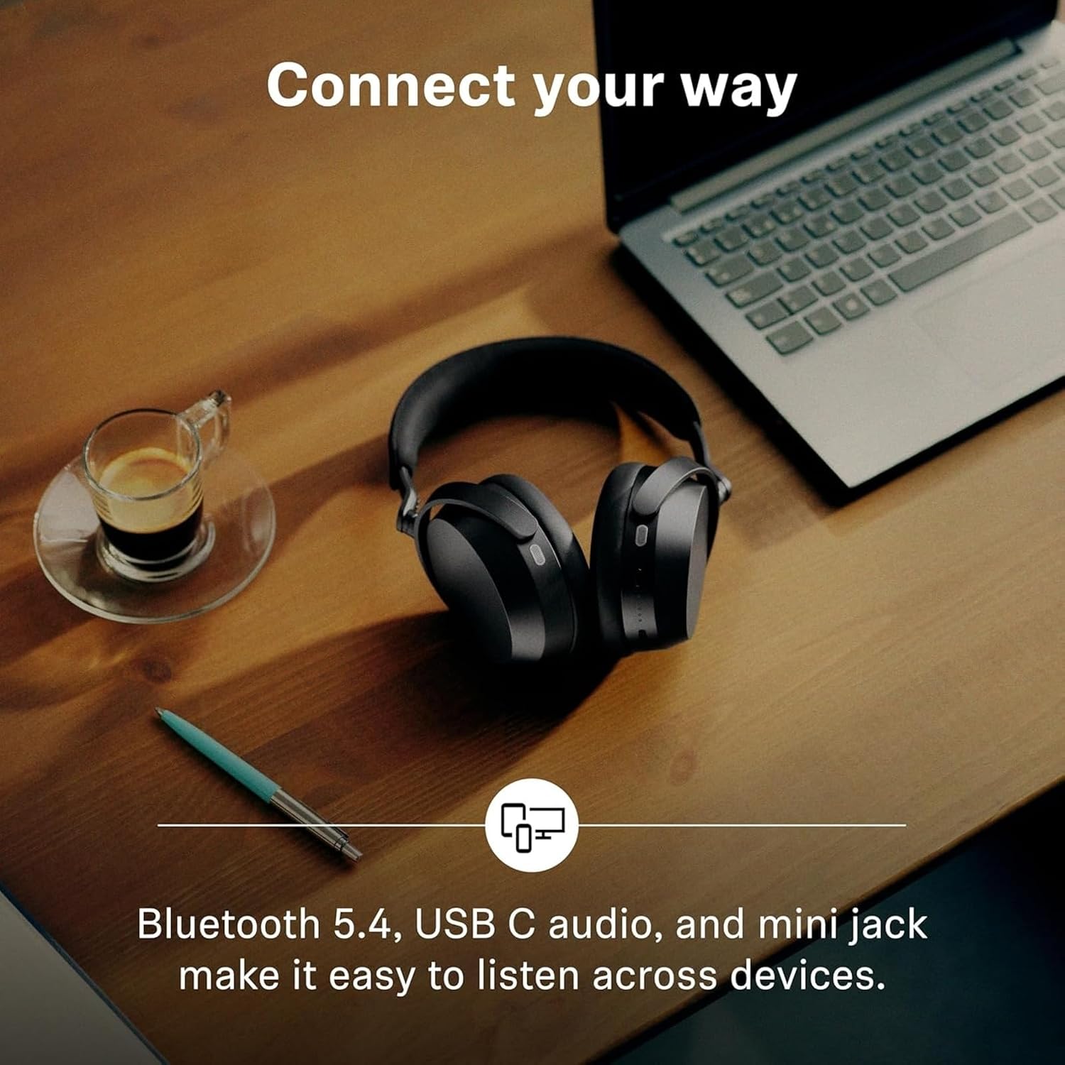 Sennheiser promotional card for the MOMENTUM 5 Wireless: a headline reading Connect your way, above black headphones on a wooden desk beside an open laptop and a glass of espresso, with a caption underneath about listening across devices.